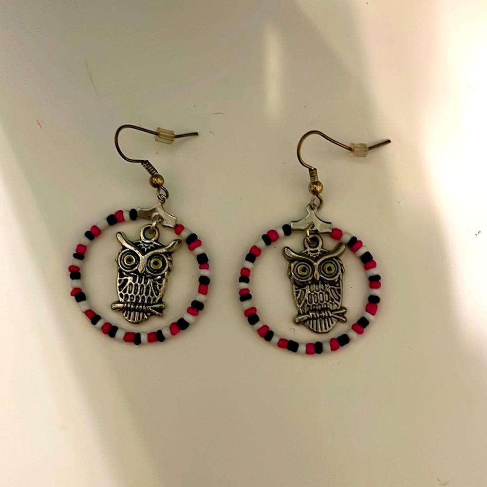 Cute pink, white, and black owl dangling hoop earrings.